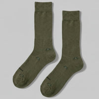 Pair of green socks on a light gray background