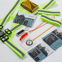 Collection of outdoor survival items including a high-visibility vest, keychain, compass